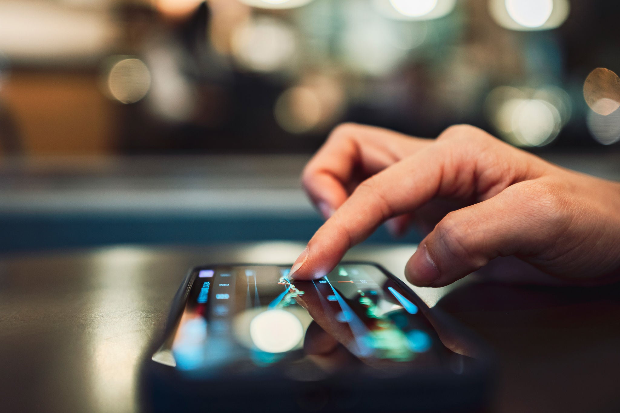 ey person checking stocks on phone hero1