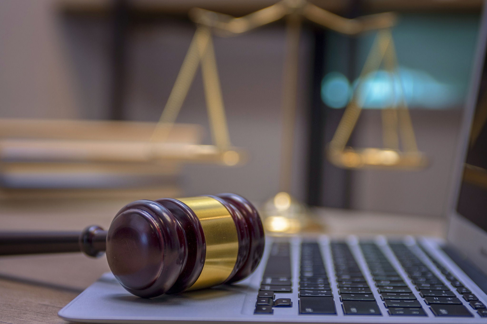 Judge gavel on laptop with scale