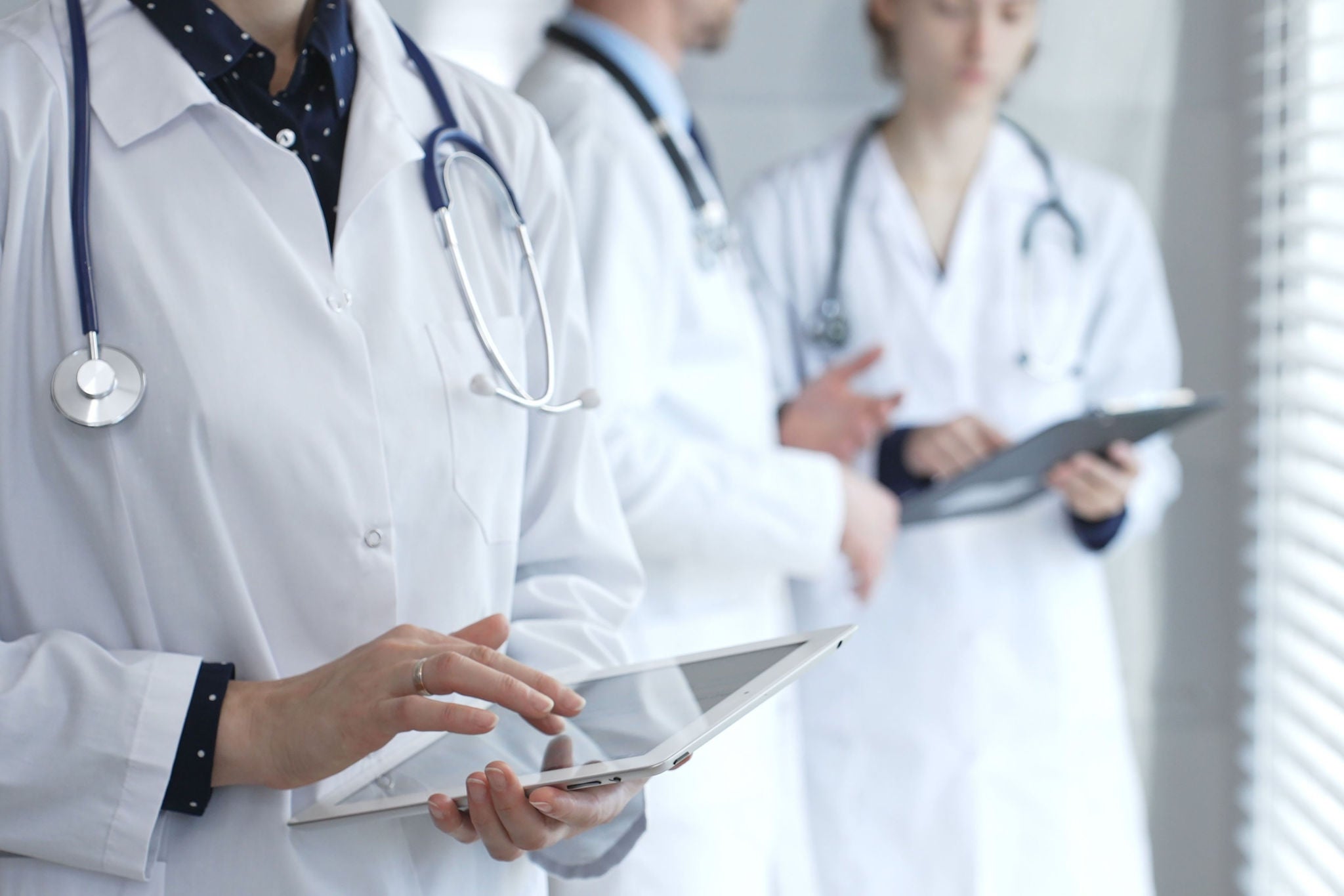 Medical professional using a digital tablet for patient care