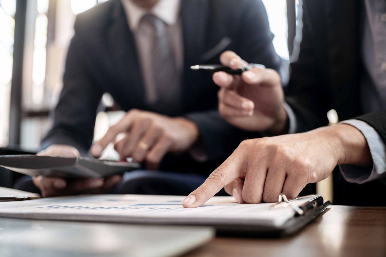 Investment and cooperate concept, business financial inspector analyzing about parformance data in office meeting.