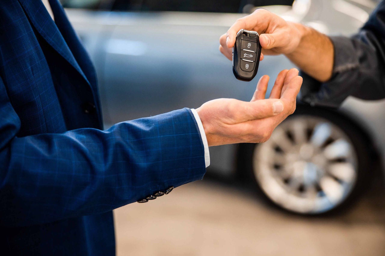 Mechanic placing an electronic device on a customers palm