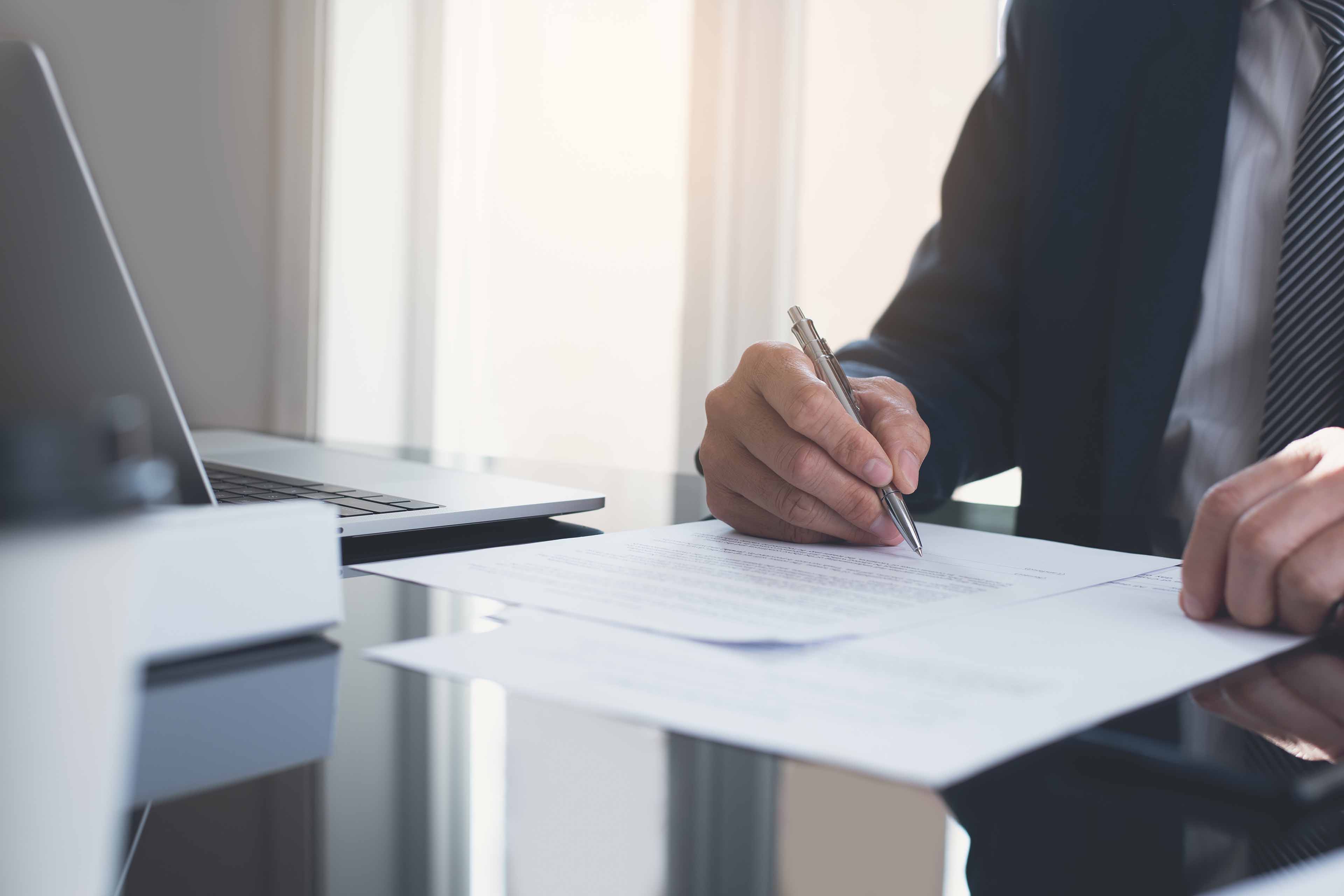 signing contract business agreement deal concept businessman signing official contract in modern office