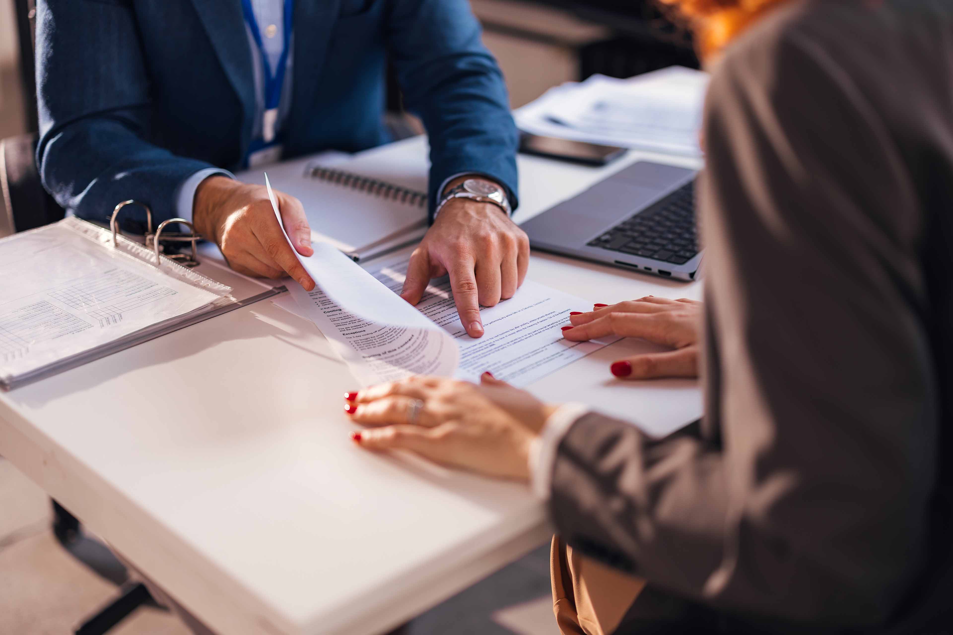 Cropped shot of diverse coworkers working together in boardroom